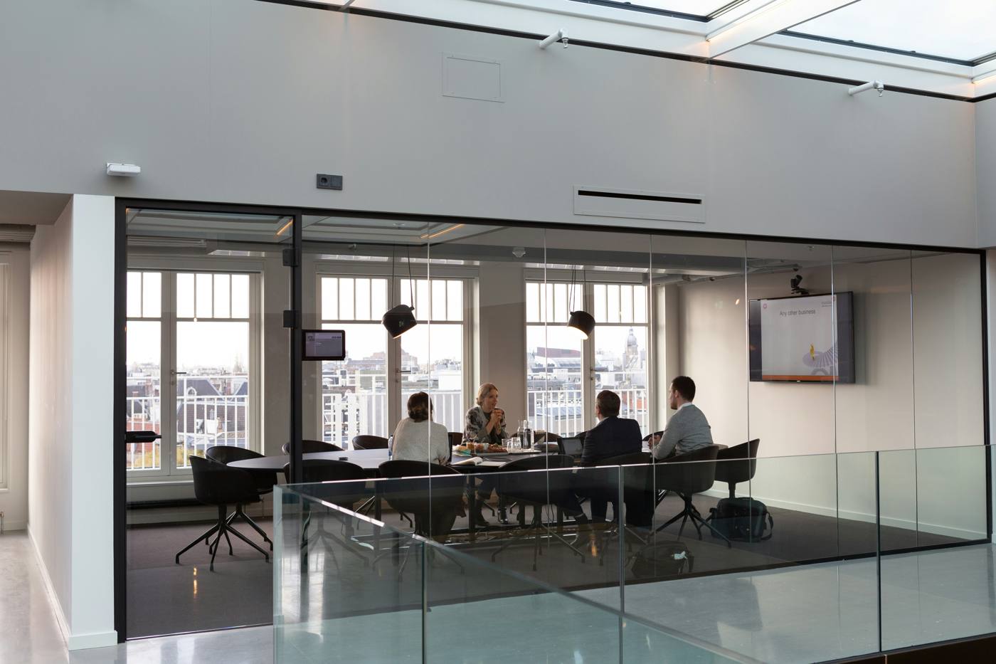 Client meeting in a glass-walled office